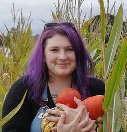 Vee doing something with fruit in a field